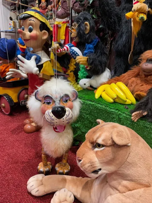 A picture of a lion Pelham puppet, a Walt Disney Pinocchio puppet, and a chimpanzee automaton.